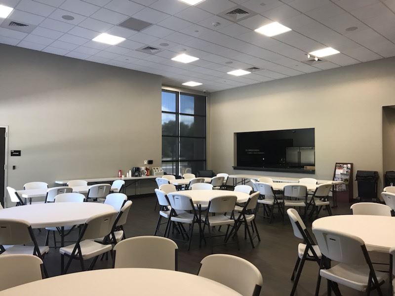 A large room featuring several tables and chairs